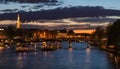 Beautiful night Paris, sparkling Eiffel tower, bridge Pont des Arts over the River Seine and touristic boats. France Royalty Free Stock Photo