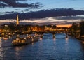 Beautiful night Paris, sparkling Eiffel tower, bridge Pont des Arts over the River Seine and touristic boats. France Royalty Free Stock Photo