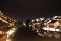 Beautiful night scene of the houses reflecting on the surface of the river in Hangzhou, China