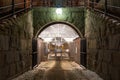 Beautiful night scene of massive stone wall and arch with bright lamp over pedestrian underground tunnel entrance in Stockholm Swe Royalty Free Stock Photo