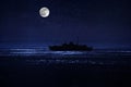 Beautiful night scene at sea. Dramatic moon over sea at night with silhouette of the ship. Selective focus