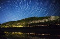 Beautiful night sky, the Milky Way, spiral star trails and the trees Royalty Free Stock Photo