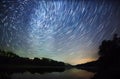 Beautiful night sky, the Milky Way, star trails and the trees