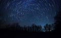 Beautiful night sky, Milky Way, star trails and the trees Royalty Free Stock Photo