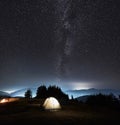 Beautiful night sky over mountain valley with camp tents. Royalty Free Stock Photo