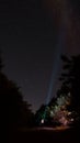 Beautiful night sky with stars and silhouette of a standing alone man on the mountain with a lantern. Blue milky way and Royalty Free Stock Photo