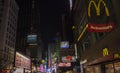 Beautiful night view of Broadway in Manhattan, with glimpse of McDonald\'s restaurant and illuminated advertising panels