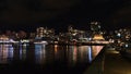 Beautiful night view of The Shipyards, a neighborhood in North Vancouver, with jetty and illuminated buildings.