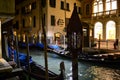 Beautiful night view to gondolas anchored in a canal near the Salvatore Ferragamo boutique. Royalty Free Stock Photo