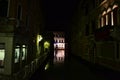 Beautiful night view to a Venice canal with reflection in water and ancient buildings. Royalty Free Stock Photo