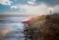 nightly seascape with lighthouse and moody sky at the sunset