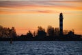 Beautiful nightly seascape with lighthouse and moody sky at the sunset