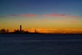 Beautiful nightly seascape with lighthouse and moody sky at the sunset