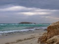 Beautiful Nissi beach with rolling sea with waves on a cloudy murky day in Ayia Napa, Cyprus Royalty Free Stock Photo