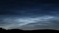 Beautiful noctilucent clouds over gentle hills