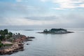 Beautiful nordic archipelago summer view of land and island against sea and hazy horizon. Royalty Free Stock Photo