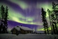 Beautiful Northern Lights Aurora Borealis in the night sky over winter Lapland landscape, Finland, Scandinavia