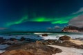 Beautiful Northern Lights in Lofoten Island in Norway. Aurora Boreal over the beach. Majestic green night sky