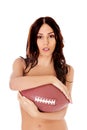 Beautiful nude woman holding american football ball. Royalty Free Stock Photo