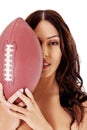 Beautiful nude woman holding american football ball. Royalty Free Stock Photo