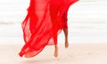 Nude woman in red fabric posing on sea beach Royalty Free Stock Photo