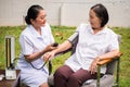 Nurse doing pressure measuring for female patient at the hospital park