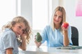 Nurse holds apple and avocado, healthy diet plan concept