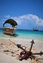 Beautiful ocean, blue sky, sand beach, anchor, boat and shells Royalty Free Stock Photo