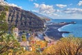 Beautiful ocean coastline with black beach sand on Puerto de Tazacorte. Colorful town houses or tourism holiday resort Royalty Free Stock Photo