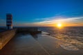 Beautiful ocean sunset at the stone pier in calm weather. Nature. Royalty Free Stock Photo