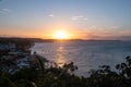 Beautiful ocean and the tree covered beach with the sunset in the background in Pipa, Brazil