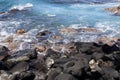 Ocean waves splashing upon black volcanic rock coastline on the Hawaiian Island of Kona, Hawaii, USA Royalty Free Stock Photo
