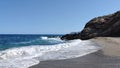 Beautiful oceanscape with rocky coastline lively waves sun and blue sky