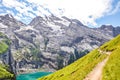 Beautiful Oeschinensee lake near Kandersteg in Switzerland. Turquoise lake surrounded by steep mountains and rocks. Popular travel