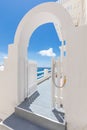 Beautiful Oia town on Santorini island, Greece. White entrance and stairs with sea view, wonderful scenery, vertical travel Royalty Free Stock Photo