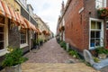 Beautiful old alley with flowers in the old city center of Delft, the Royalty Free Stock Photo