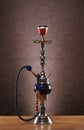 An old blue ceramic hookah on a blue background