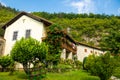 Beautiful old buildings decorated with flowers near the monastery church somewhere far in the mountains of montenegro, religion Royalty Free Stock Photo