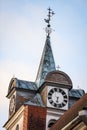 Beautiful old church tower with clock. Old building with cloudy overcast background Royalty Free Stock Photo