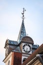 Beautiful old church tower with clock. Old building with cloudy overcast background Royalty Free Stock Photo