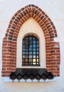 Beautiful Old Church Window. The window is decorated with red brick on a white wall