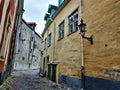 Beautiful old cobblestone street with colorful houses in Tallinn Royalty Free Stock Photo