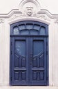 Beautiful old dark blue wooden door. Fragment of the facade of the house Royalty Free Stock Photo