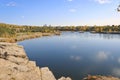 Beautiful old granite quarry with clear water in Indian summer. Chelyabinsk, Russia Royalty Free Stock Photo