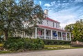 A beautiful old house with a wrap around porch.