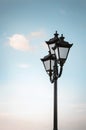 Beautiful old lantern on a background of blue sky. Vertical photography Royalty Free Stock Photo