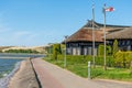 Beautiful old Lithuanian traditional wooden blue houses with thatched roof and old boat Royalty Free Stock Photo