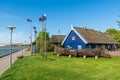 Beautiful old Lithuanian traditional wooden houses with thatched roof, white desert dunes Royalty Free Stock Photo