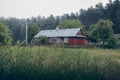 Beautiful, old, polish village with traditional agricultural buildings situated in the middle of the forest on a foggy day. Royalty Free Stock Photo