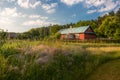 Beautiful, old, polish village with traditional agricultural buildings situated in the middle of the forest in the morning light. Royalty Free Stock Photo